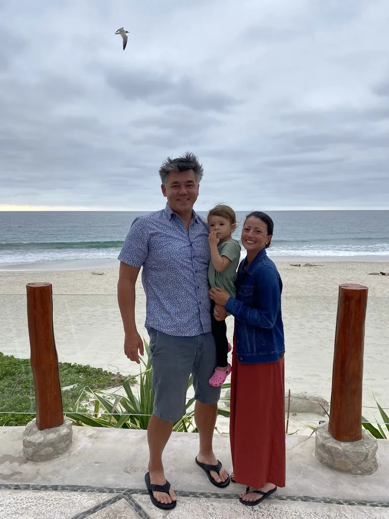 Andrew, Marie, and Zoe standing on an ocean terrace in Mexico