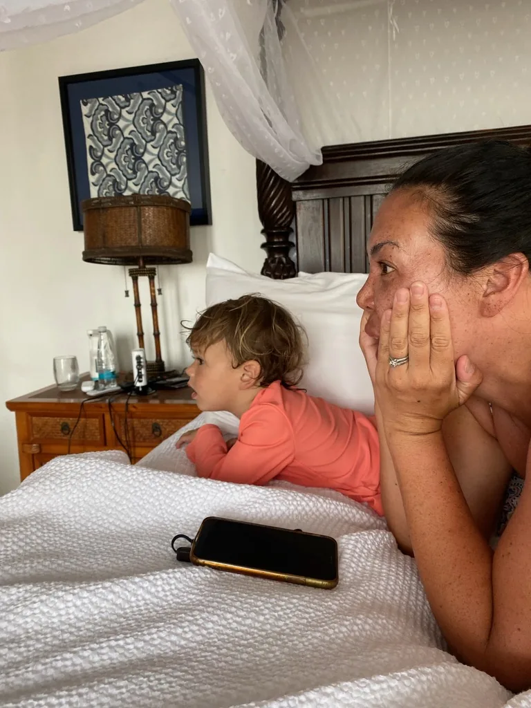 Marie and Zoe watching something from a bed