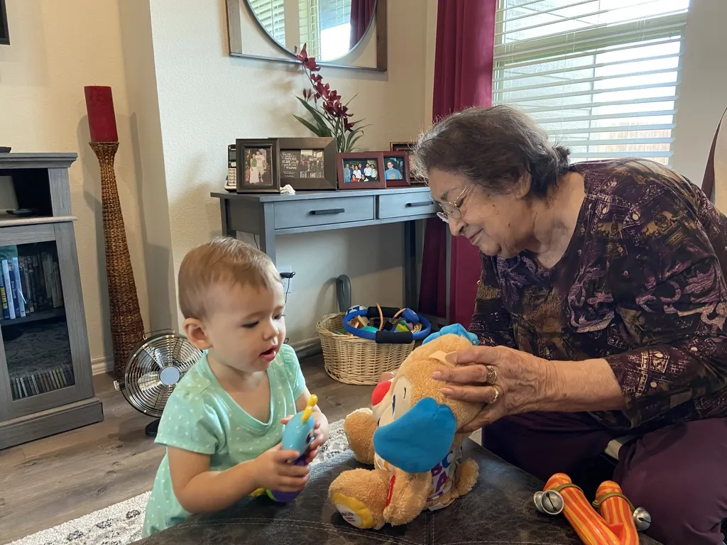 Zoe playing with a toy dog with her great-grandmother in North Texas