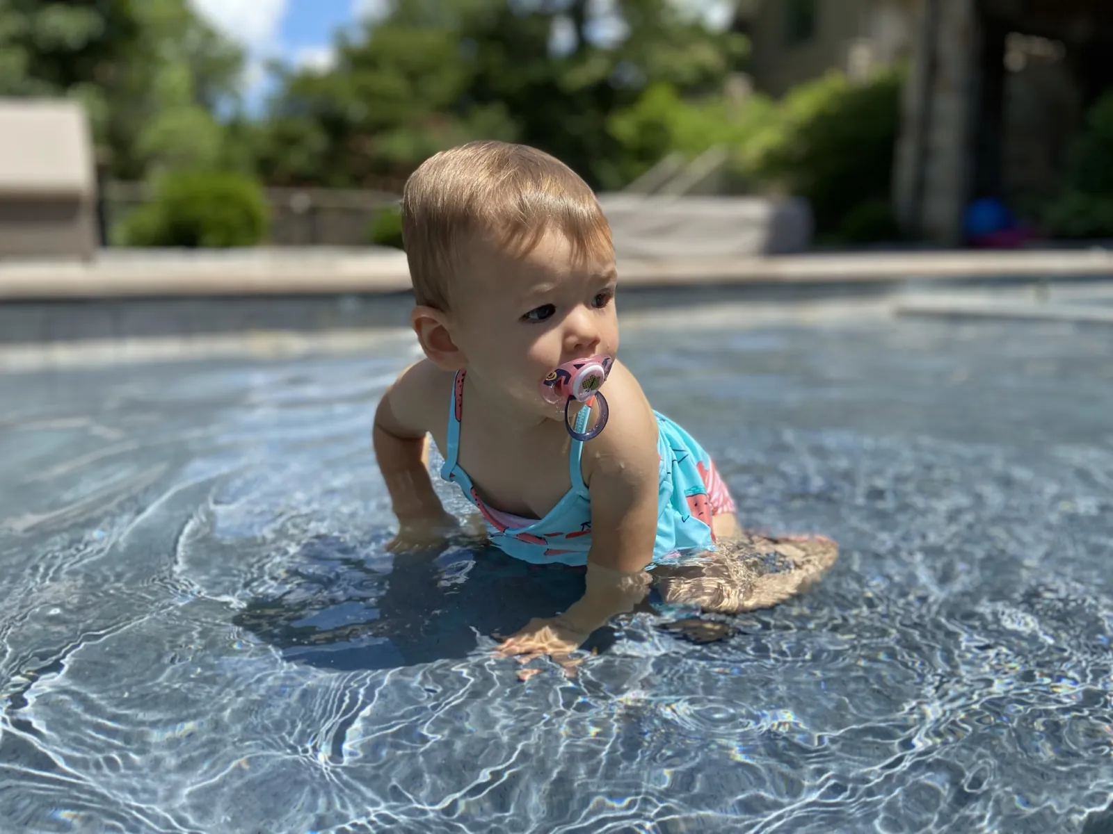 Zoe crawling through shallow pool water in Raleigh