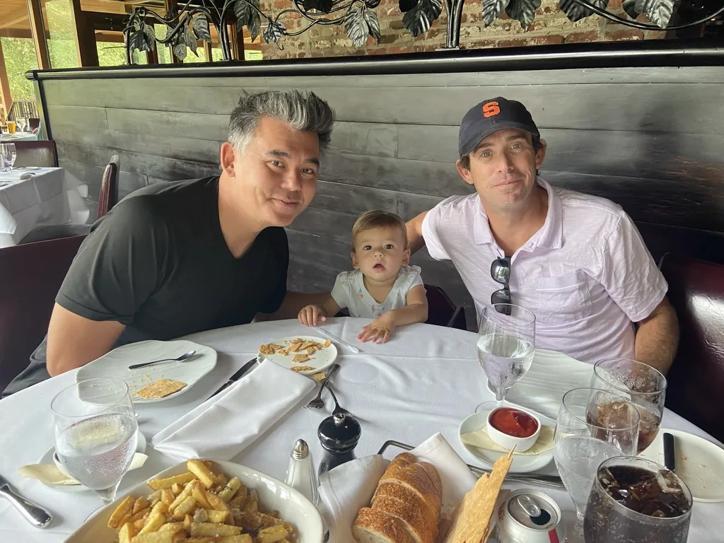 Andrew and family sitting with Zoe at a restaurant table in Atlanta
