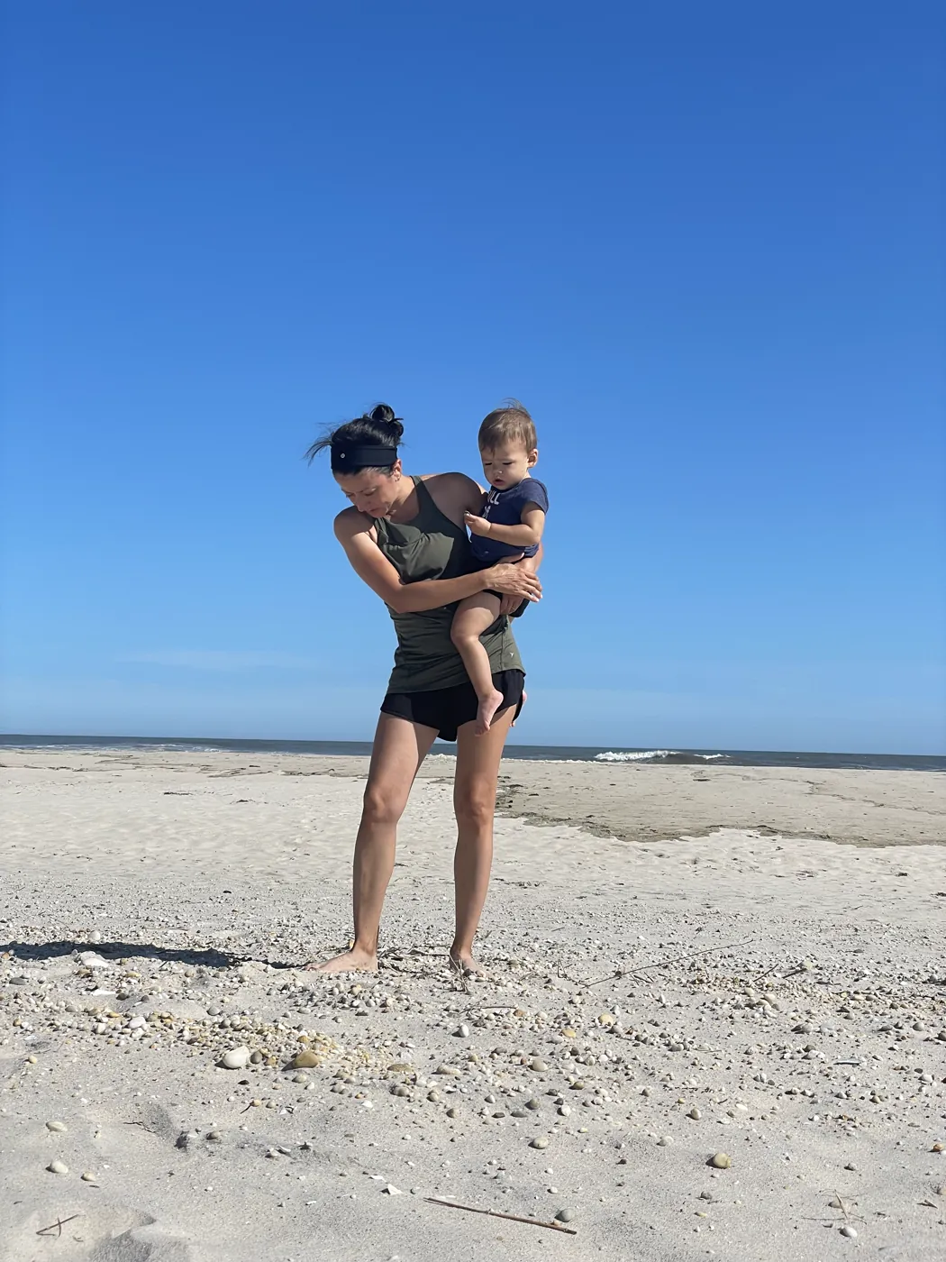 Marie carrying Zoe on the beach in Westhampton