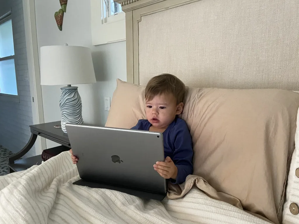 Zoe sitting in bed and holding an iPad