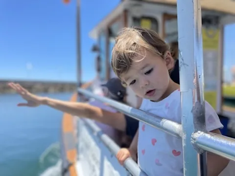 Zoe leaning over the railing on Lil' Toot