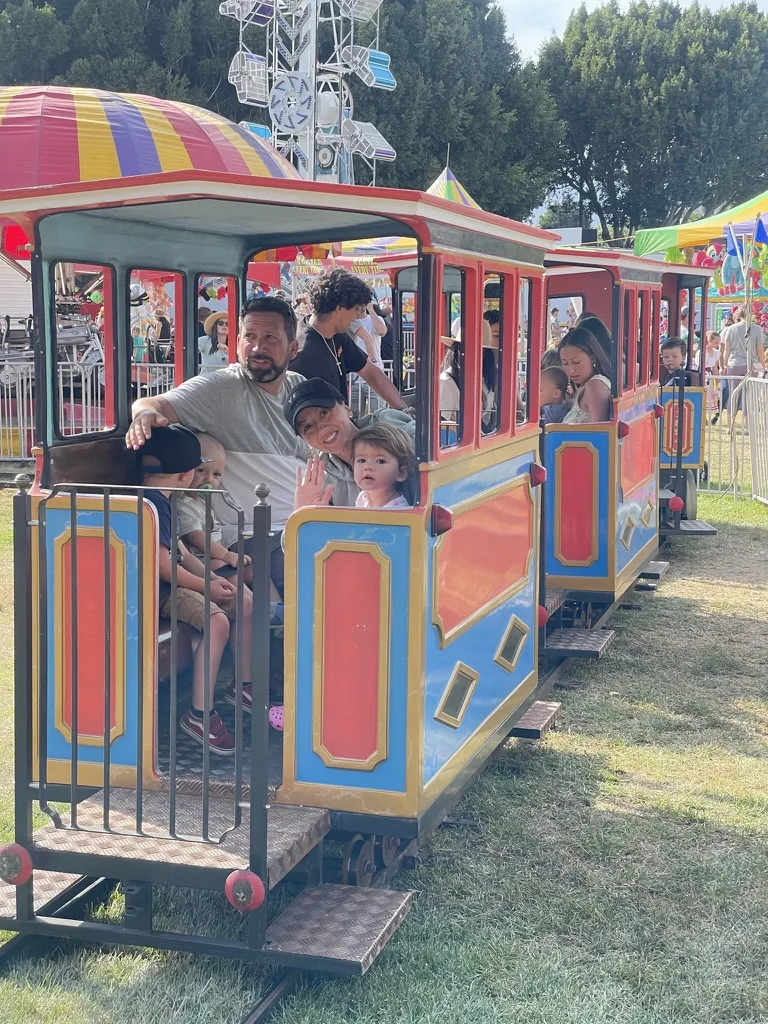 Zoe and family riding a small carnival train