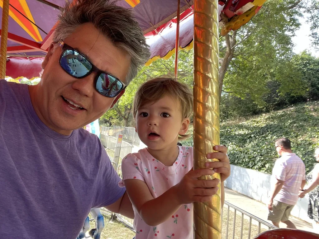 Andrew and Zoe sitting on a carousel