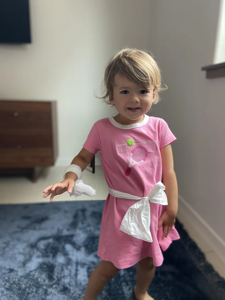 Zoe wearing a pink dress with improvised white bandages