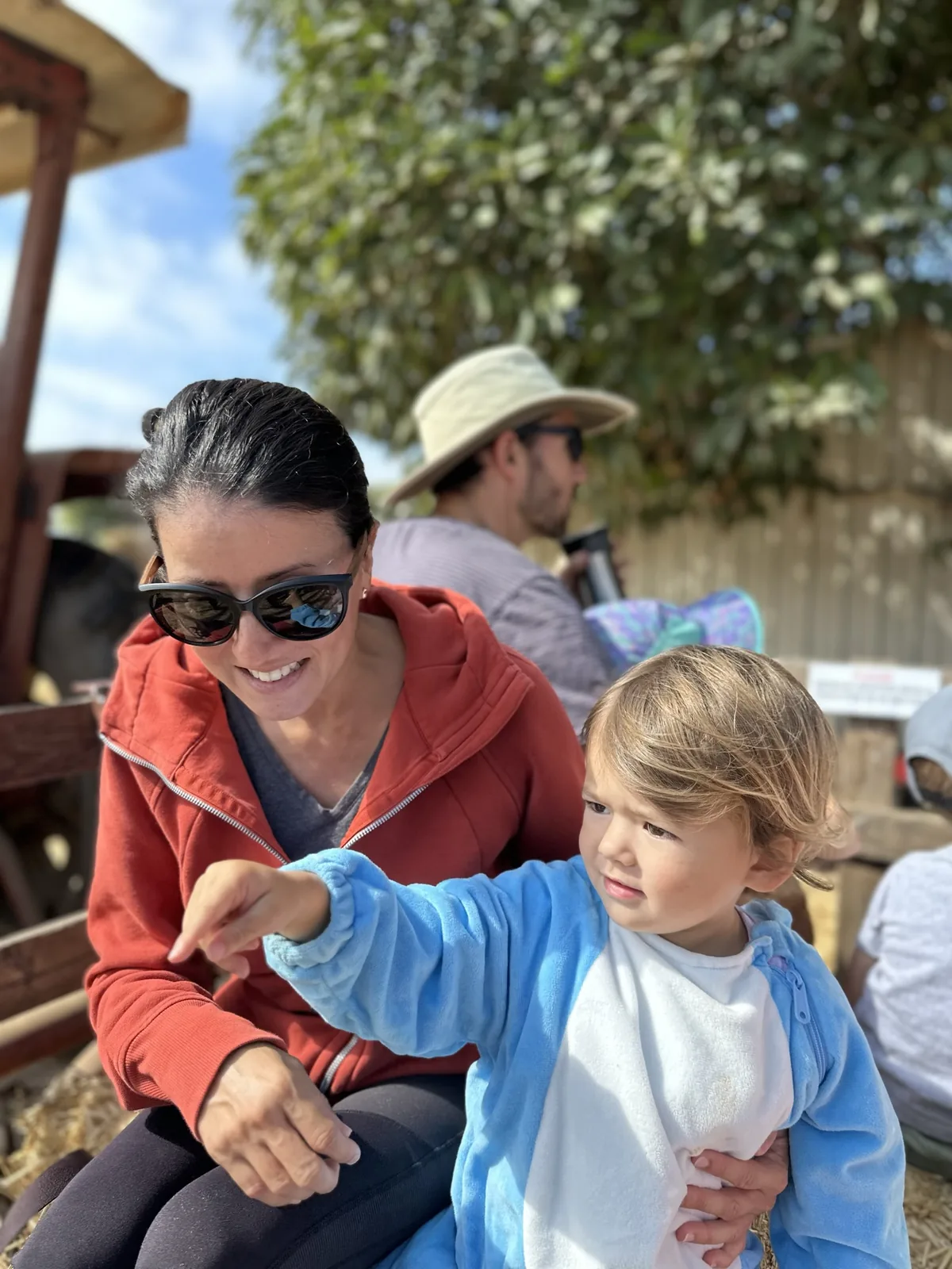 Marie and Zoe sitting together at a pumpkin patch