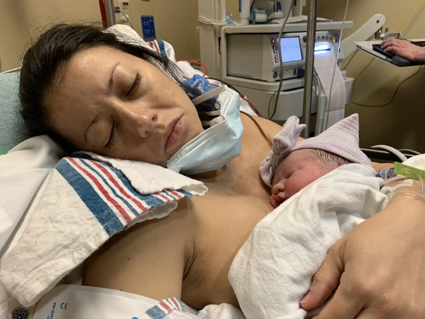 Marie holding newborn Zoe in an Austin hospital room