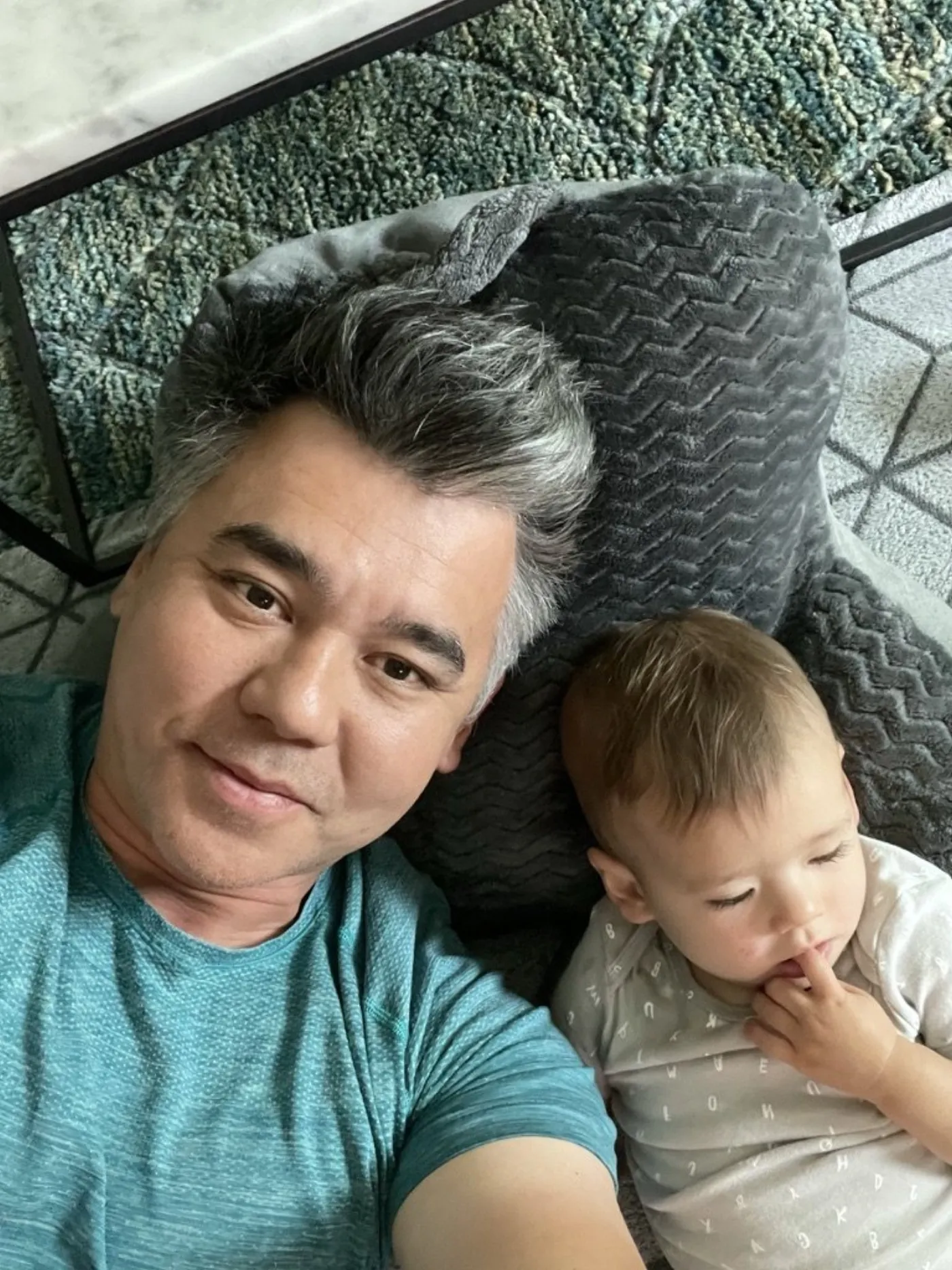 Andrew taking a selfie with Zoe on the rug