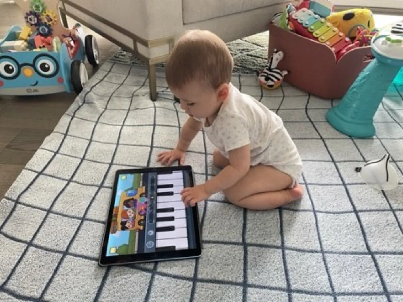 Zoe playing a piano app on a tablet
